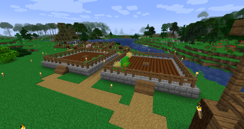 overview of a farming area, with two crop fields and several animal pens beyond