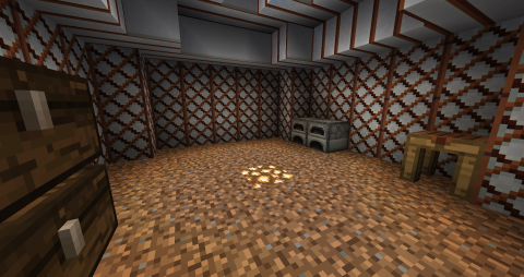 the interior of a yurt, with a dirt floor lit by glowstone in the center, and along the walls are a chest, crafting station, and furnaces