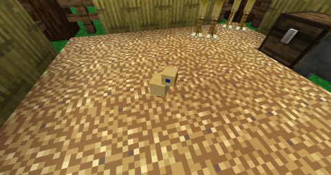 a baby chocobo sits on a bed of straw