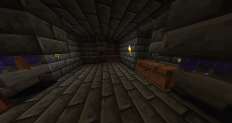 a small dark brick room, the feet of many zombies can be seen standing above hoppers on three sides of the room