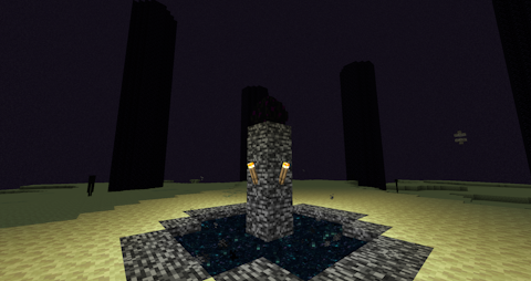 a dragon egg sits above a bedrock portal in the End